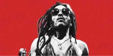 Lenny Kravitz Stars in Town Person mit Sonnenbrille vor rotem Hintergrund.